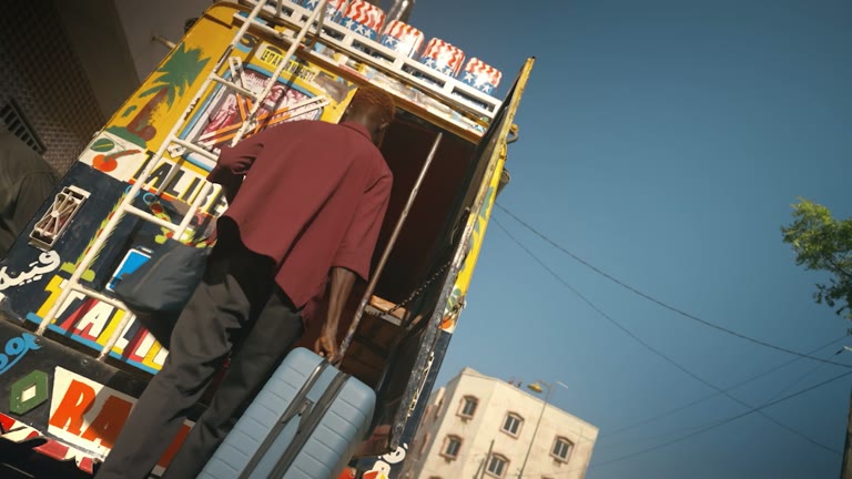 A traveler boards a Dakar bus with Away luggage