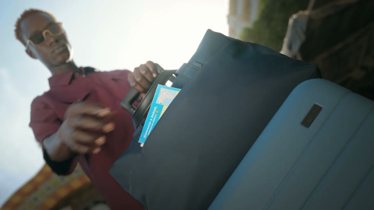 A traveler packs an Away suitcase